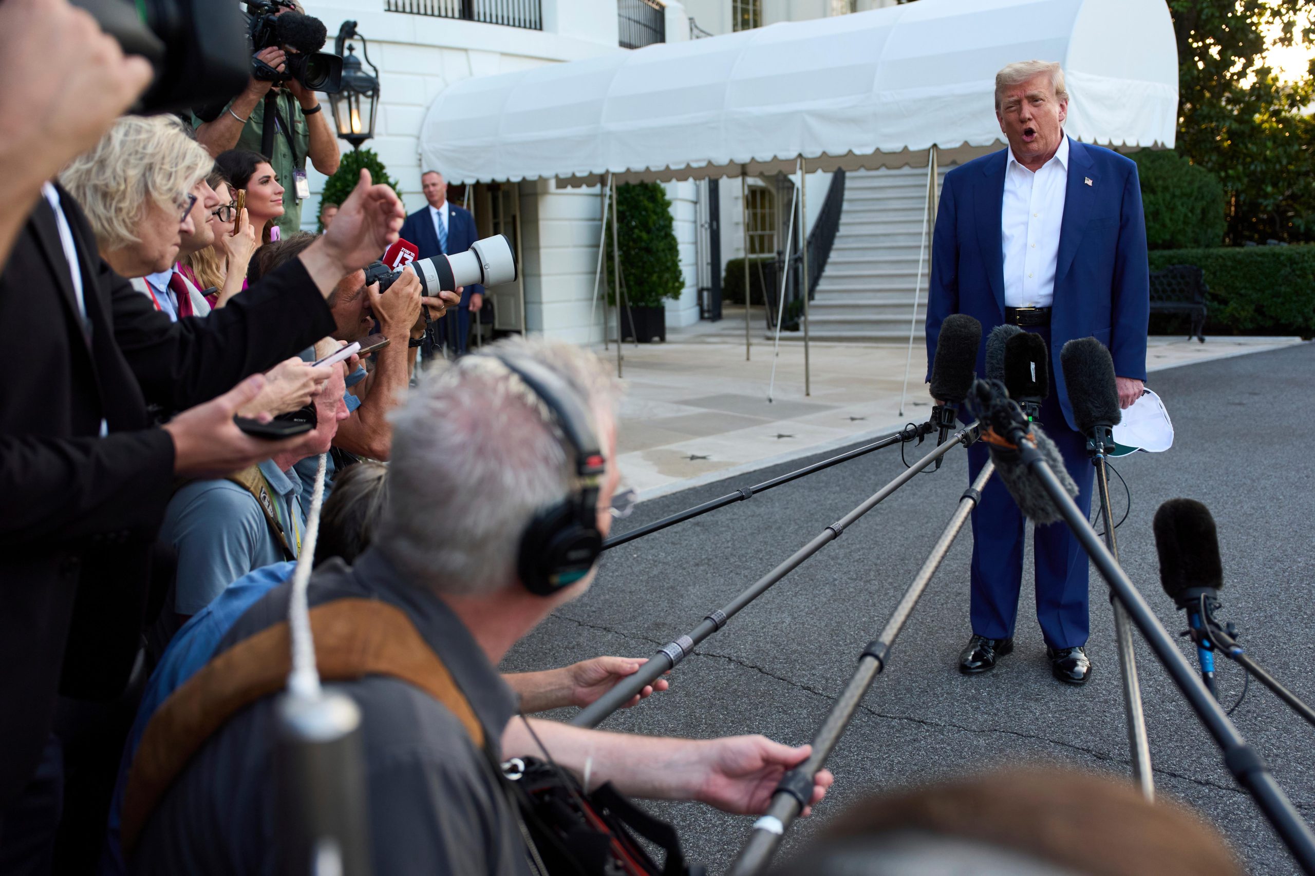 President Donald Trump speaks with reporters before boarding Marine One...