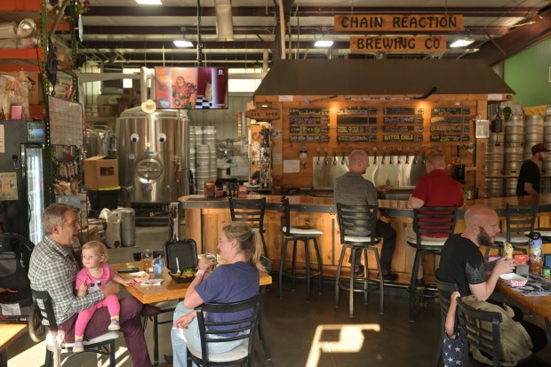 People hang out at Chain Reaction Brewing Company in Denver on July 10, 2025. (Photo by RJ Sangosti/The Denver Post)