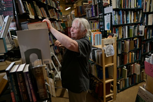 Owner Lois Harvey sorts books at West Side Books in Denver on Tuesday, Aug. 19, 2025. (Photo by Hyoung Chang/The Denver Post)